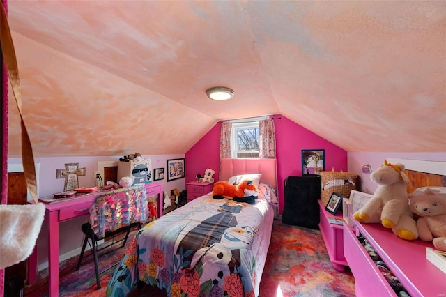 bedroom with vaulted ceiling and a textured ceiling