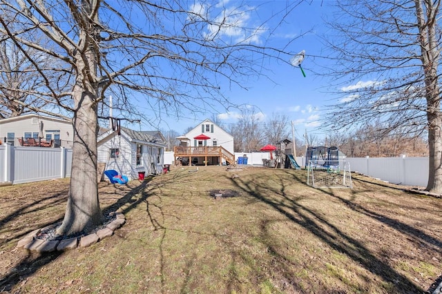 view of yard featuring a trampoline and a fenced backyard