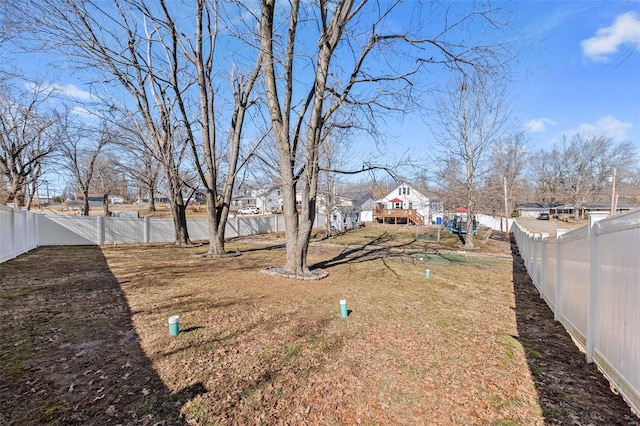 view of yard with a fenced backyard and a residential view