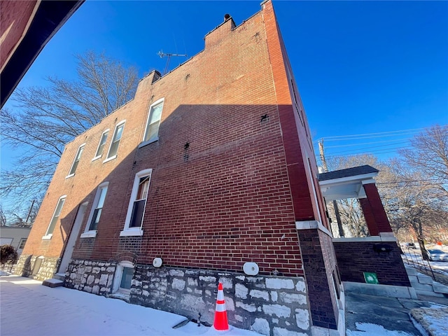 view of side of property featuring brick siding