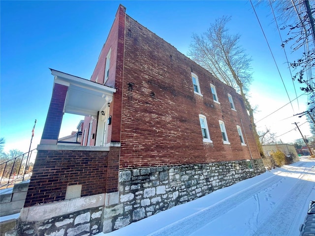 view of side of property featuring brick siding