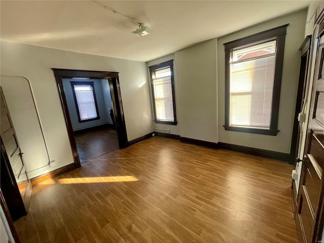 interior space with wood finished floors and baseboards