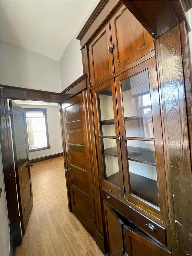 interior space featuring light wood finished floors and baseboards