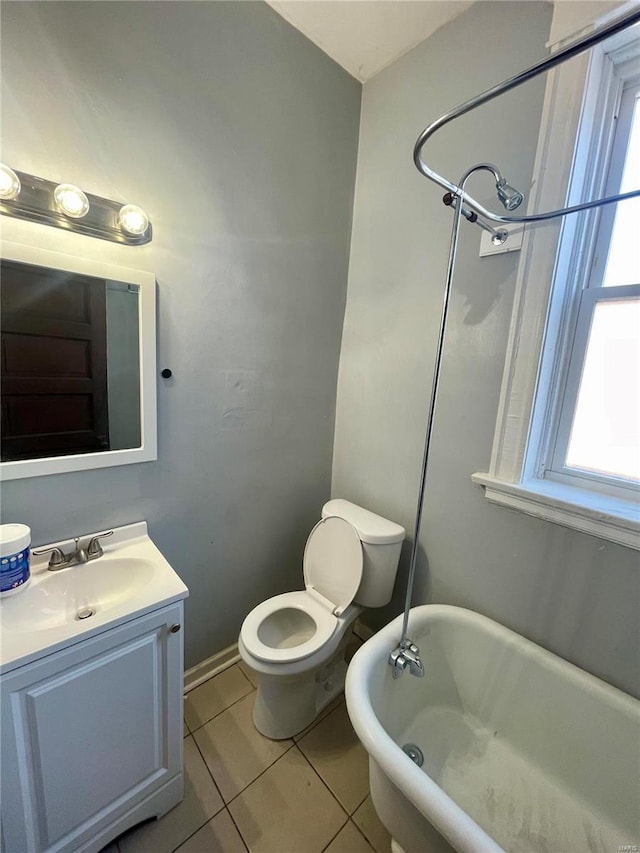 full bathroom with toilet, vanity, tile patterned flooring, and a bath