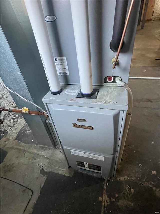 utility room featuring heating unit