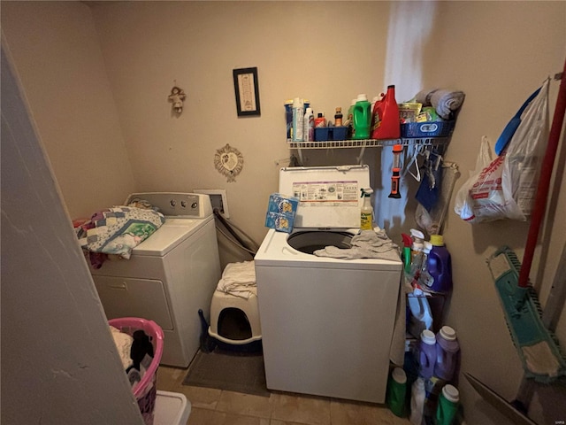 laundry area with tile patterned flooring, laundry area, and separate washer and dryer