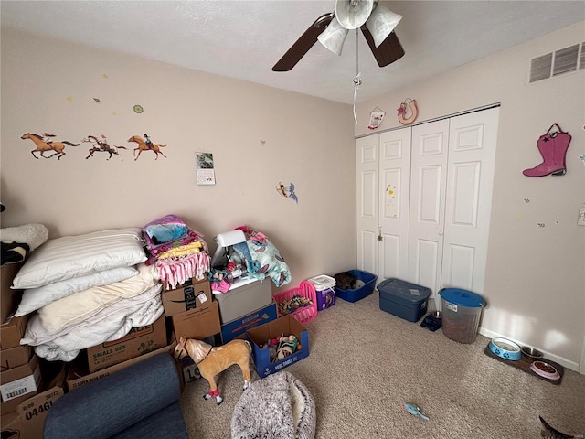 bedroom with baseboards, visible vents, a ceiling fan, carpet floors, and a closet