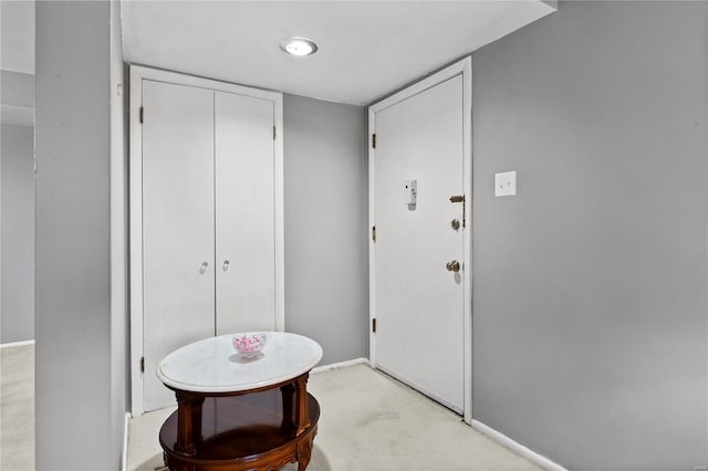 foyer featuring baseboards