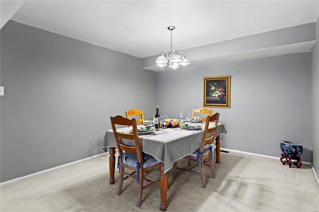 dining area featuring baseboards, carpet flooring, and an inviting chandelier