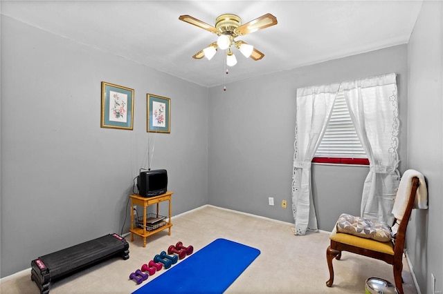 exercise room with ceiling fan, carpet, and baseboards