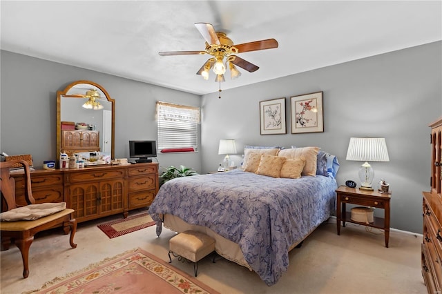 bedroom featuring light colored carpet and ceiling fan