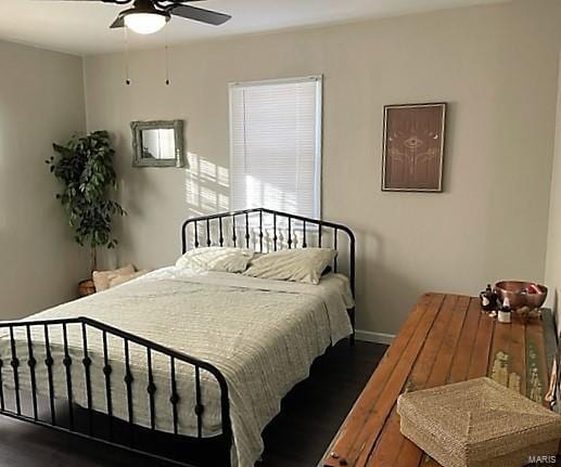 bedroom with ceiling fan, baseboards, and wood finished floors