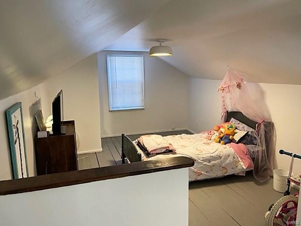 bedroom featuring vaulted ceiling and wood finished floors