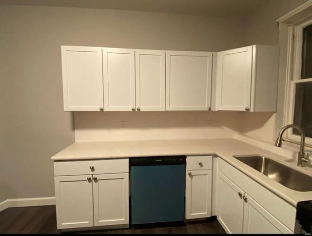 kitchen with a sink, white cabinets, dishwasher, and light countertops