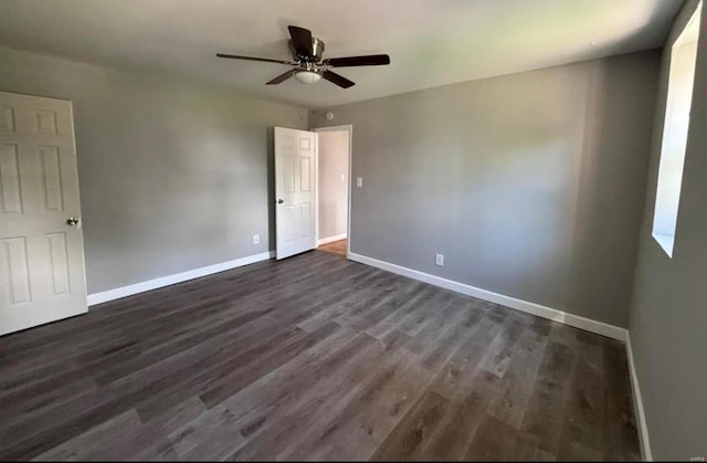 unfurnished bedroom with ceiling fan, baseboards, and dark wood-type flooring