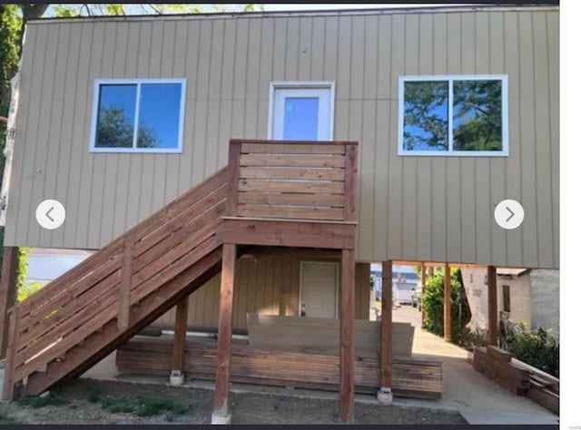 back of property featuring a deck and stairs