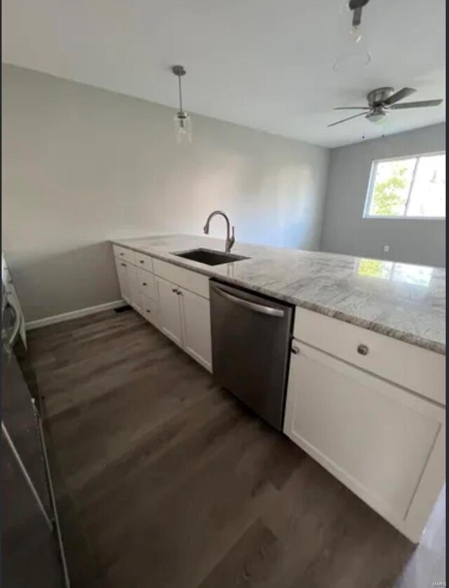 kitchen with dark wood-type flooring, light stone countertops, stainless steel dishwasher, white cabinetry, and a sink