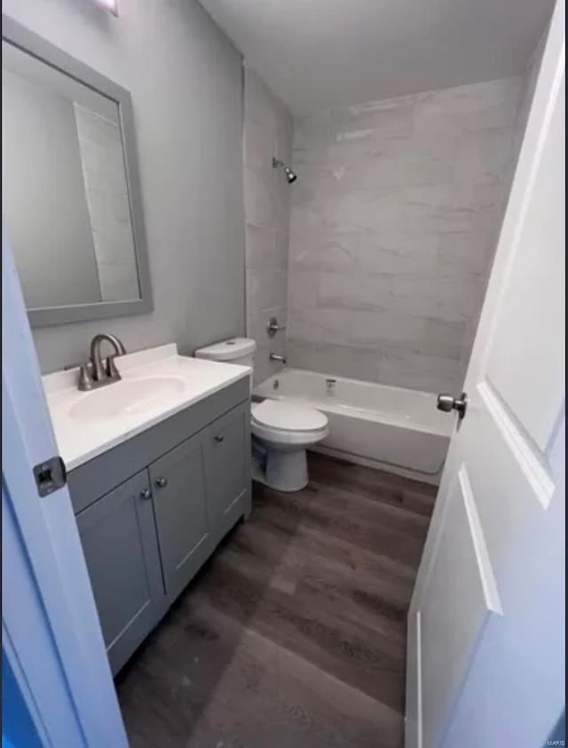 full bathroom with vanity, shower / bathing tub combination, wood finished floors, and toilet