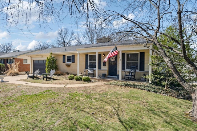 view of front of house featuring a front lawn, a porch, an attached garage, brick siding, and a chimney