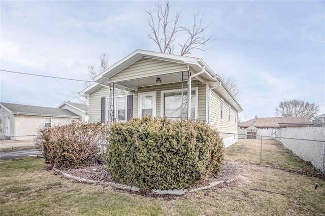 bungalow-style home featuring fence and a front yard