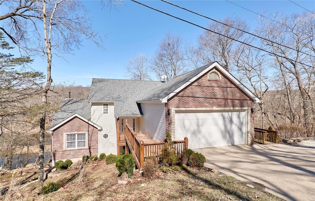 view of front of property featuring concrete driveway, brick siding, roof with shingles, and an attached garage