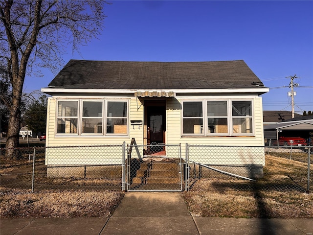 bungalow-style house featuring a fenced front yard and a gate