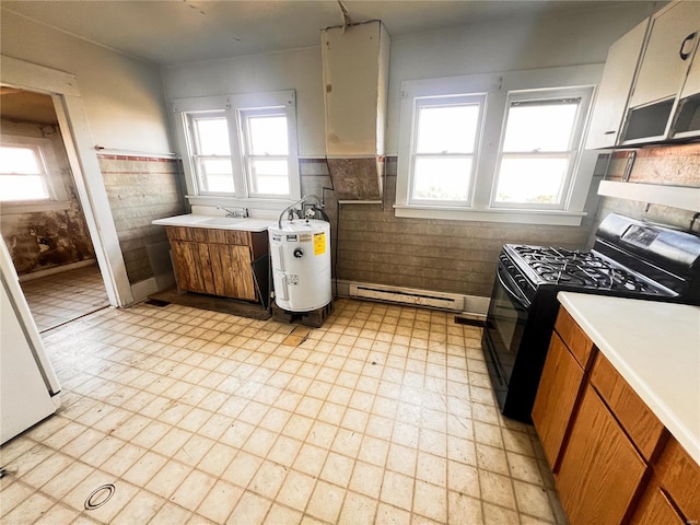 kitchen with light floors, light countertops, black range with gas cooktop, electric water heater, and baseboard heating