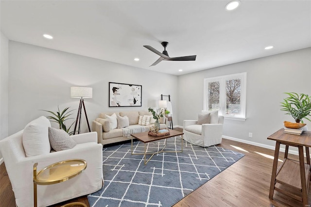 living area with a ceiling fan, recessed lighting, baseboards, and wood finished floors