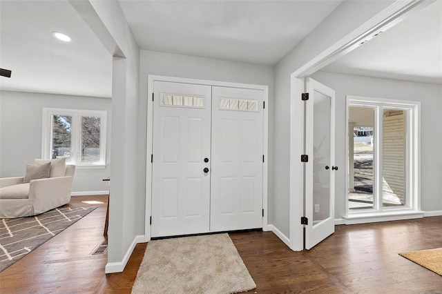 entrance foyer with recessed lighting, dark wood finished floors, and baseboards