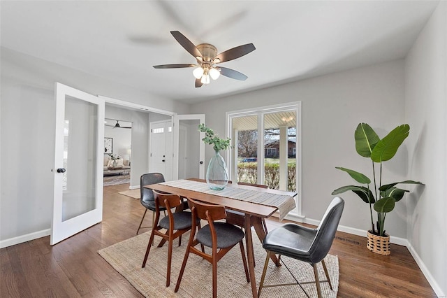 dining room with french doors, ceiling fan, baseboards, and wood finished floors