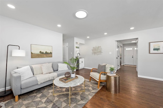 living room featuring baseboards, wood finished floors, and recessed lighting