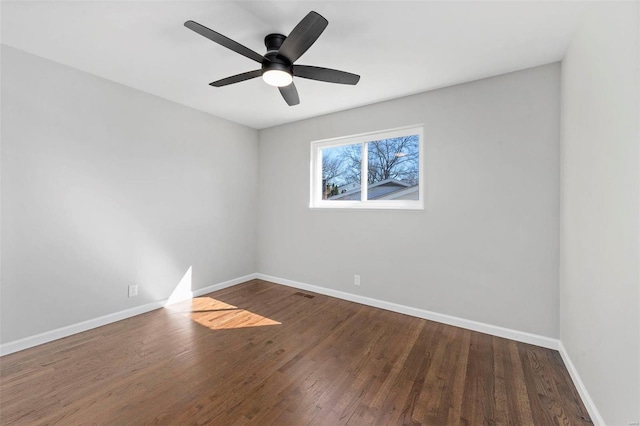 unfurnished room featuring a ceiling fan, visible vents, baseboards, and wood finished floors