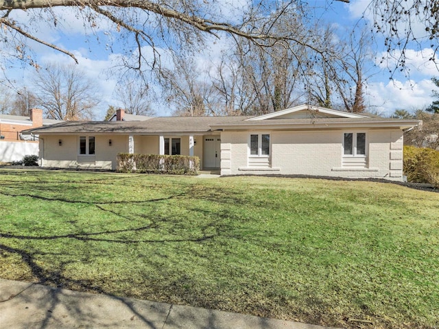 ranch-style home with a front yard and brick siding