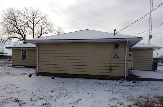 view of snow covered exterior featuring a garage and crawl space