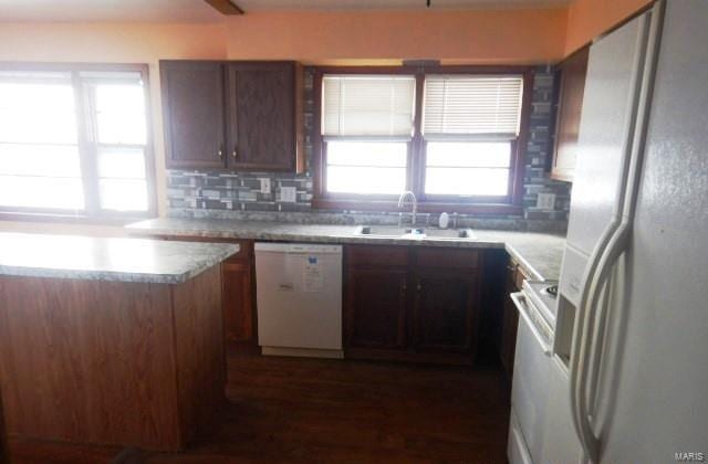 kitchen featuring range, a sink, white dishwasher, refrigerator with ice dispenser, and backsplash