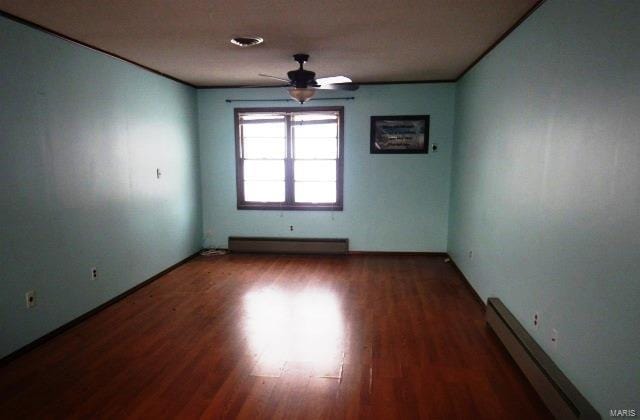 unfurnished room featuring a ceiling fan, baseboard heating, and wood finished floors