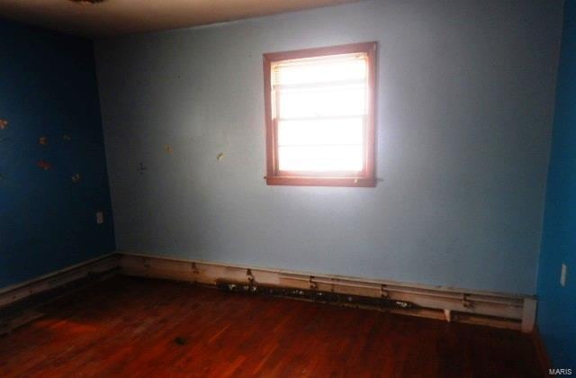 empty room with wood finished floors