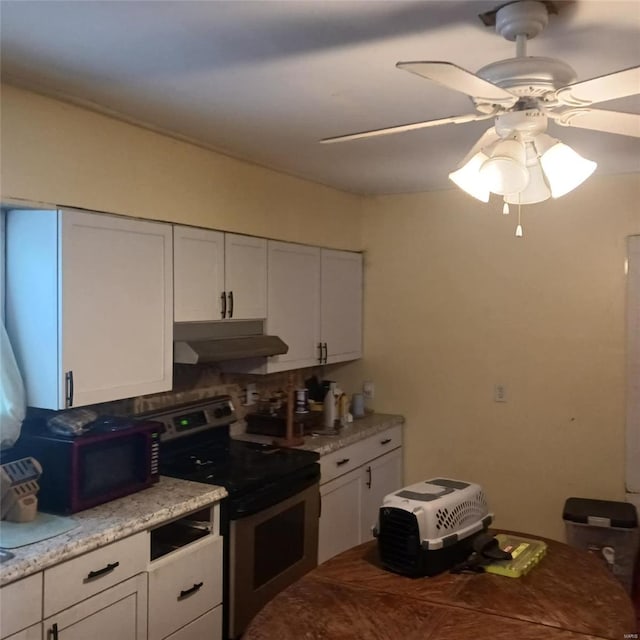 kitchen featuring ceiling fan, light stone countertops, stainless steel electric range, under cabinet range hood, and white cabinetry