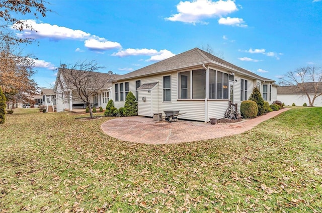 view of front of house featuring a patio, a front lawn, and a sunroom