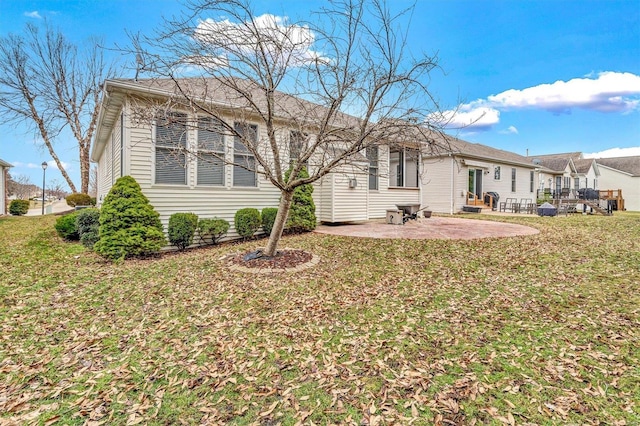 rear view of house with a yard and a patio area