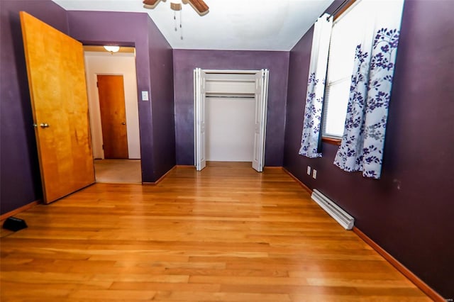 unfurnished bedroom featuring light wood-style flooring, visible vents, ceiling fan, and a closet