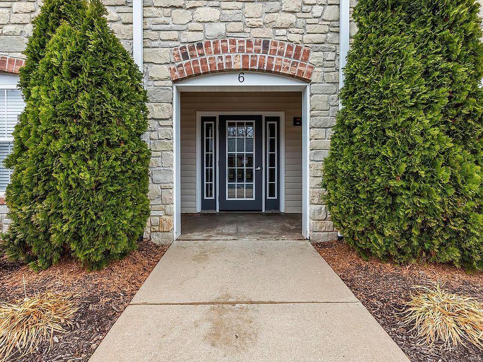 doorway to property featuring stone siding