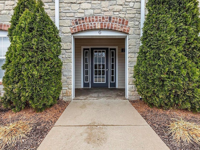 doorway to property featuring stone siding