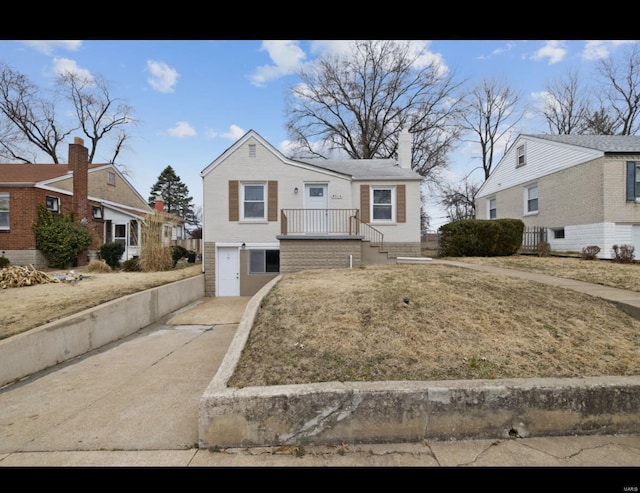 view of front of house with driveway and a chimney