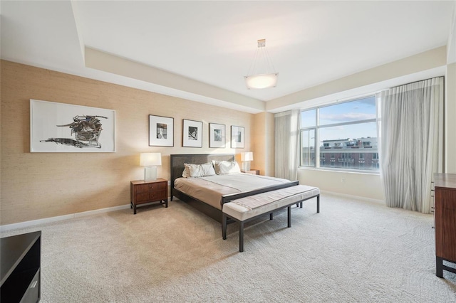 bedroom with light carpet and baseboards