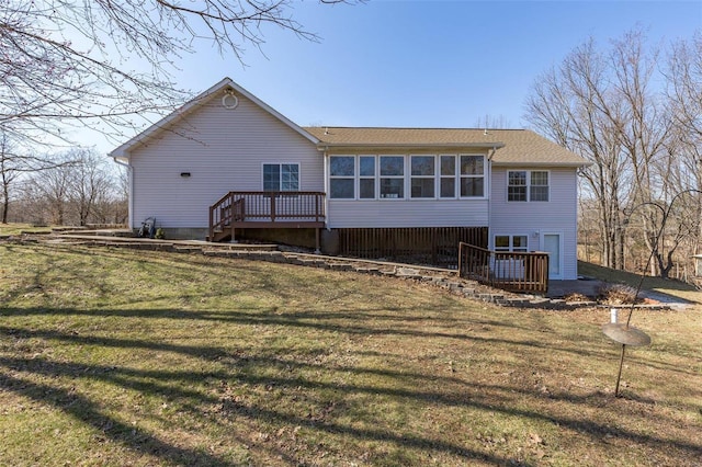 rear view of property with a deck and a yard