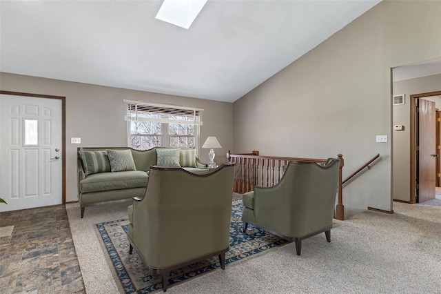 living room featuring vaulted ceiling with skylight, visible vents, and baseboards