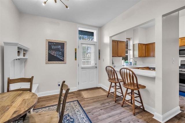 dining area featuring plenty of natural light, wood finished floors, and baseboards