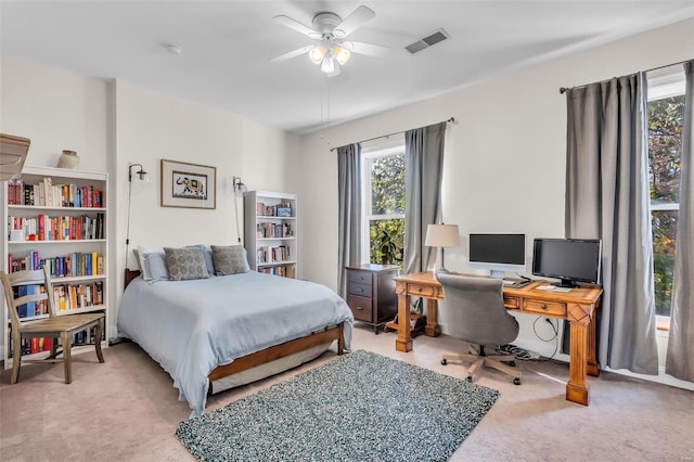 carpeted bedroom featuring visible vents and a ceiling fan