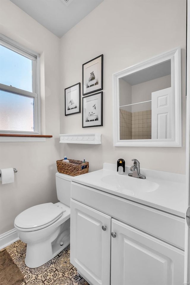 full bathroom with vanity, baseboards, walk in shower, tile patterned floors, and toilet